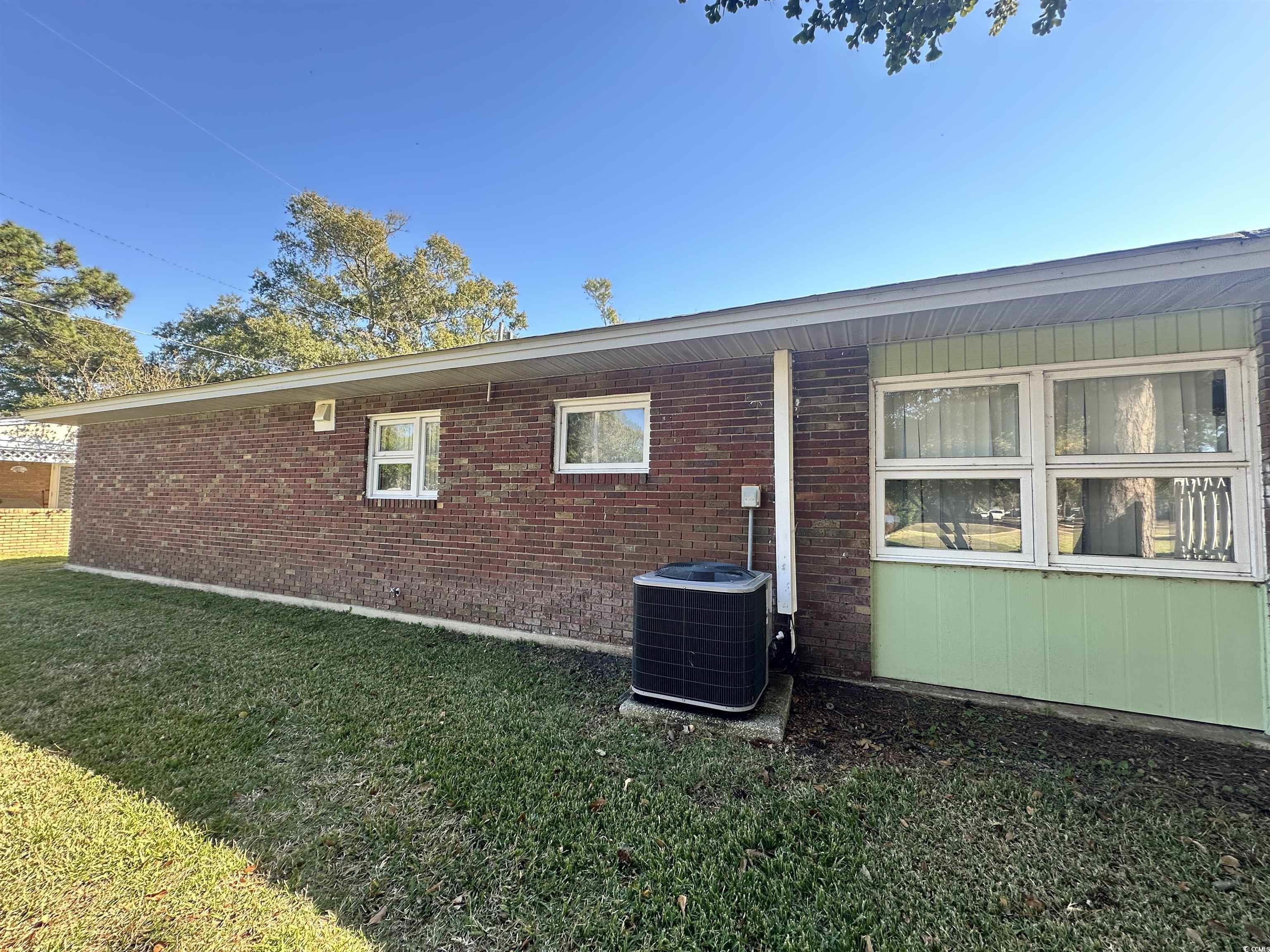 539 Redwood Avenue, Unit 539 Myrtle Beach, SC 29577 - Photo 7 of 23 View of back of home with a lawn, shade trees and brick siding