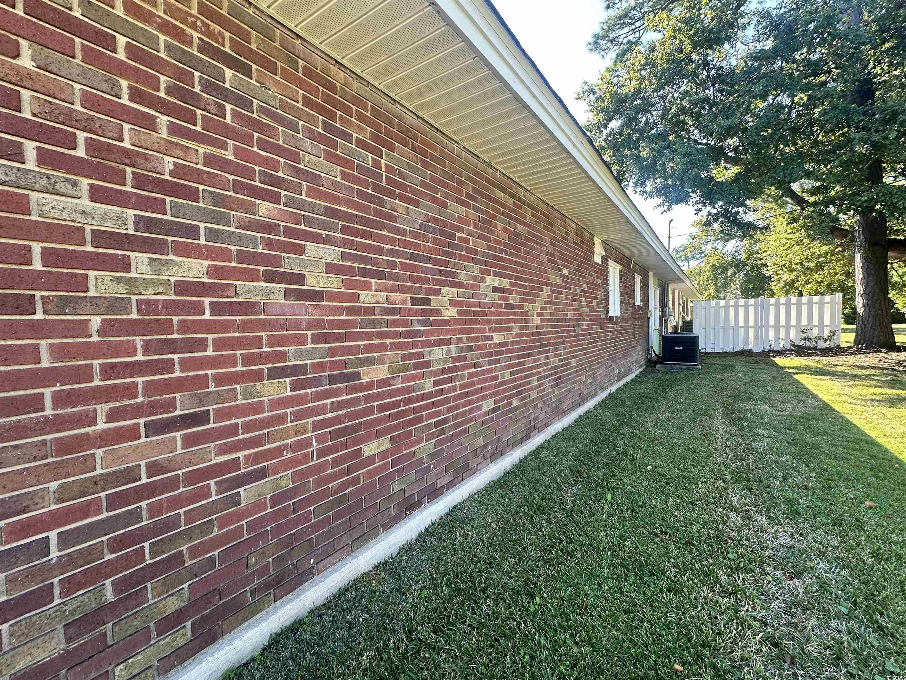 539 Redwood Avenue, Unit 539 Myrtle Beach, SC 29577 - Photo 8 of 23 View of property exterior with brick siding and a cooling unit