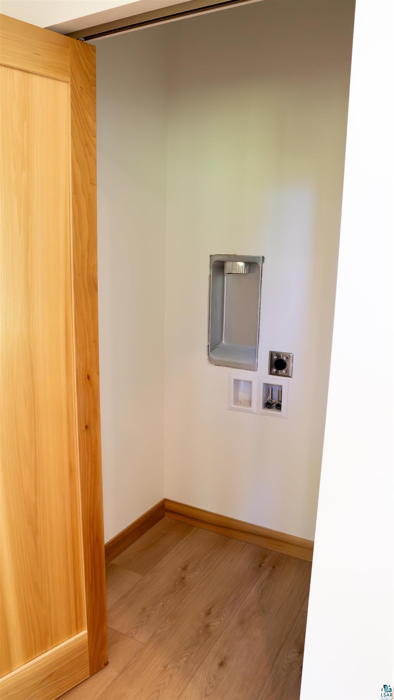 89180 Meadow Trail Cornucopia, WI 54827 - Photo 15 of 26 Laundry room featuring hookup for a washing machine, electric dryer hookup, and light wood-type flooring