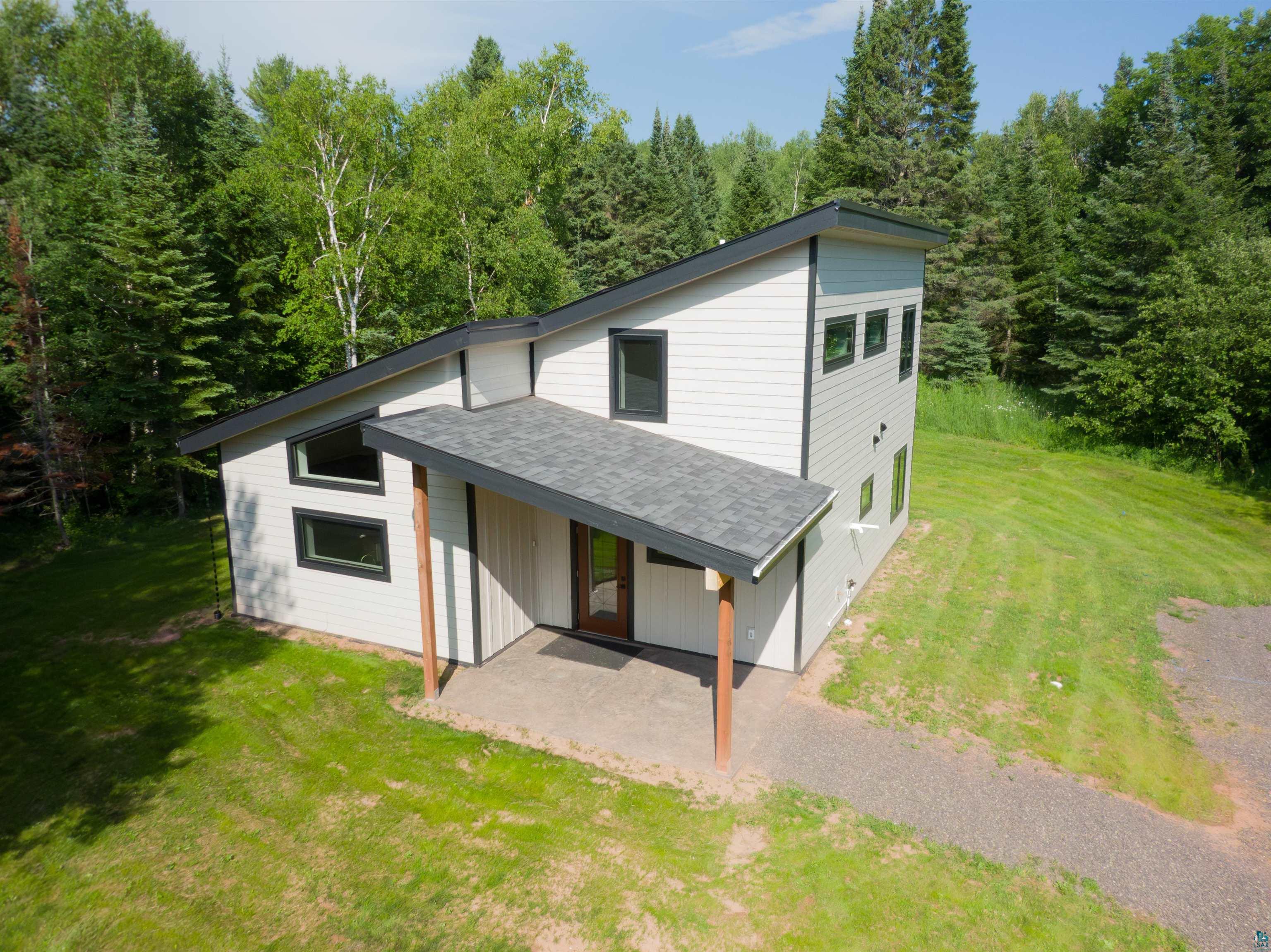 89180 Meadow Trail Cornucopia, WI 54827 - Photo 3 of 26 View of front of home with a patio and a front lawn