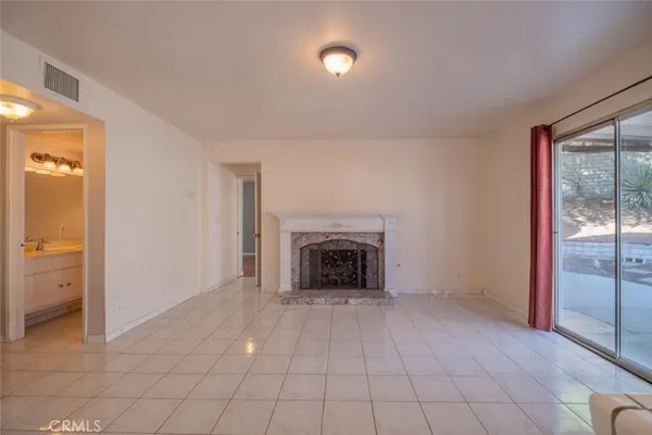 wooden floor fireplace and windows in a room