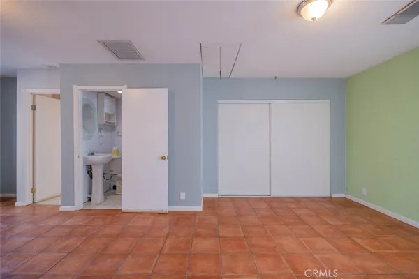 a view of a big room with closet and chandelier fan