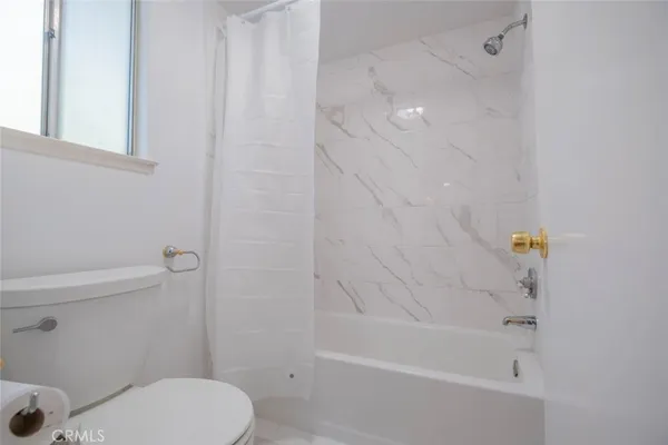 a bathroom with a bathtub and a toilet