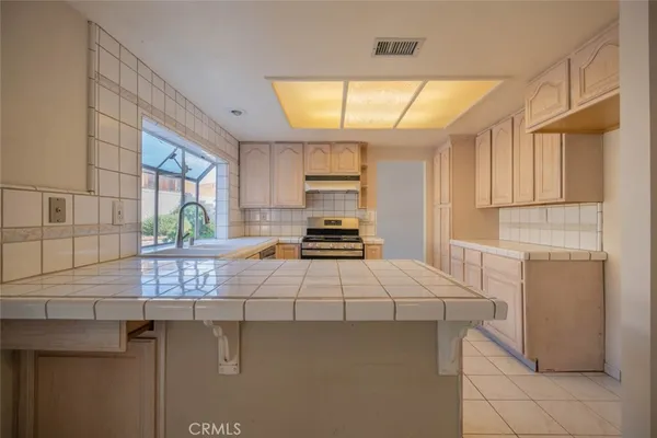 a kitchen with a sink cabinets and window