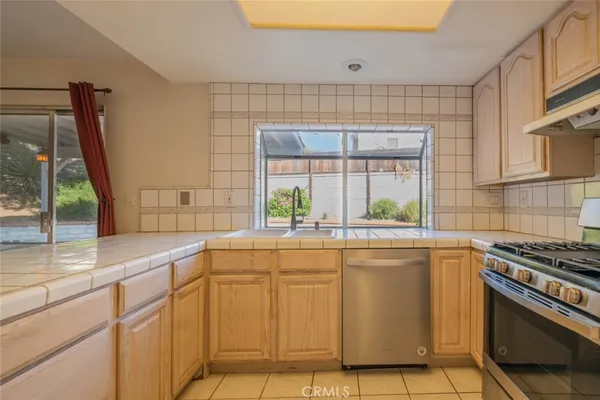 a kitchen with cabinets and window
