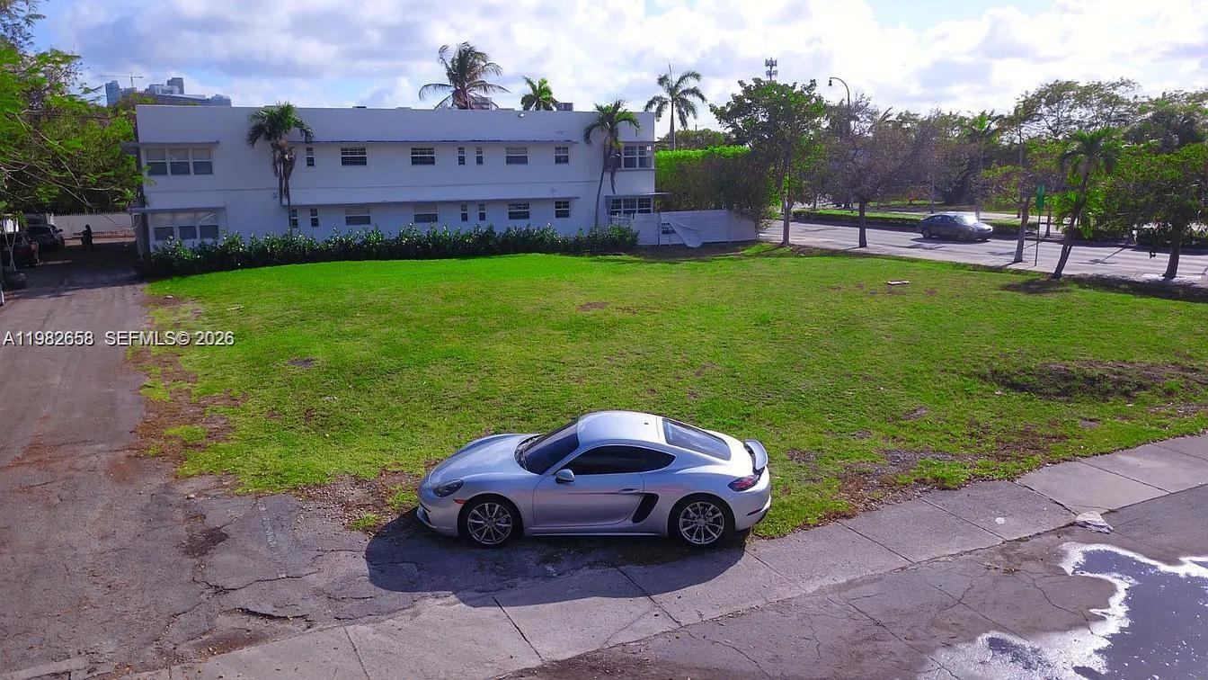 5215 Biscayne Boulevard Miami, FL 33137 - Photo 12 of 13 a view of a house with a yard and a fire pit