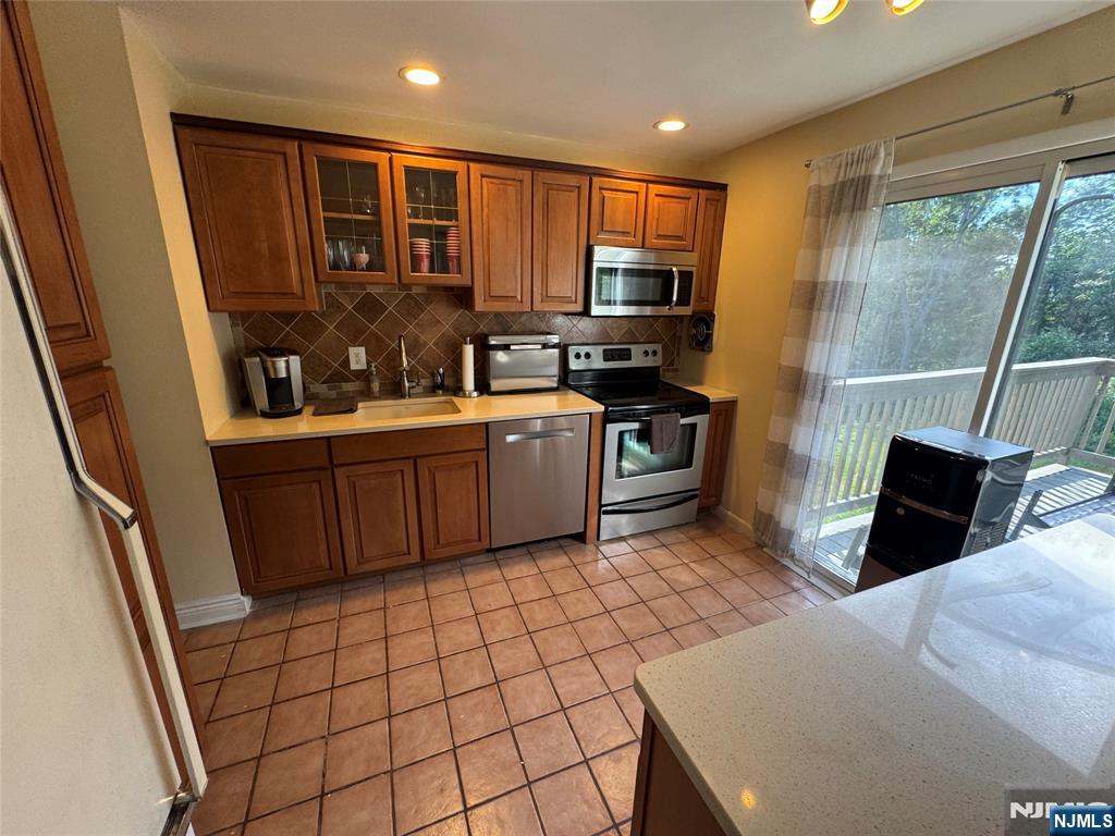 55 Maryann Road Oak Ridge, NJ 07438 - Photo 13 of 20 a kitchen with stainless steel appliances a stove a sink and a refrigerator