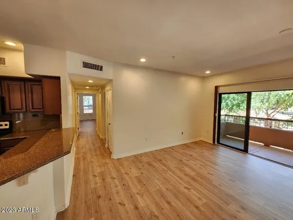 a view of a kitchen with wooden floor and a sink