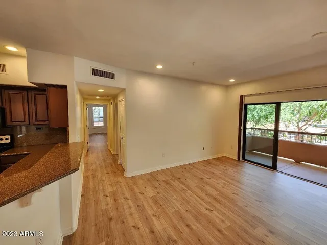 a view of a kitchen with wooden floor and a sink