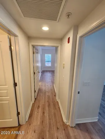 a view of a hallway with wooden floor