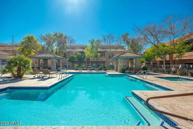 a view of a house with swimming pool and sitting area