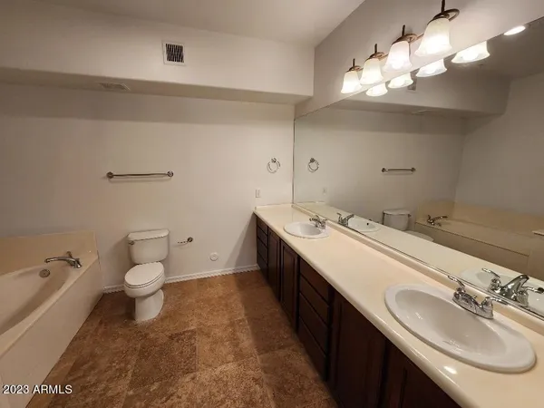 a bathroom with a double vanity sink and a toilet
