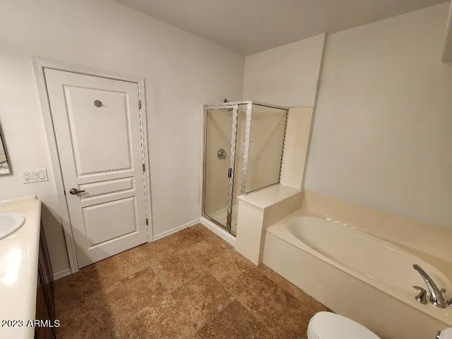 a bathroom with a tub and shower