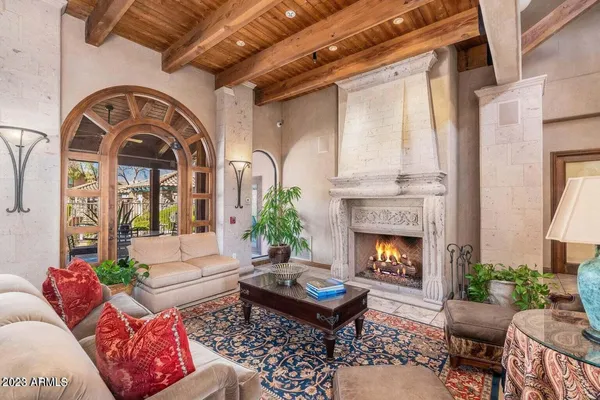 a living room with furniture fireplace and window