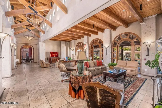 a view of a patio with a table and chairs under an umbrella