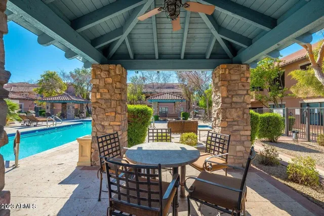 a view of a swimming pool with lounge chairs in patio