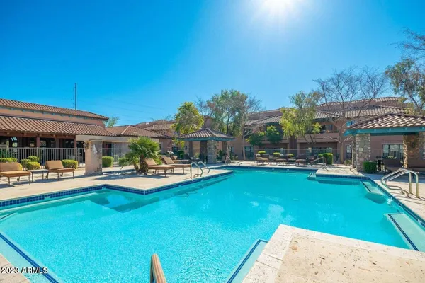 a view of house with swimming pool outdoor seating