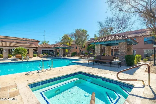 a view of a patio with iron fence
