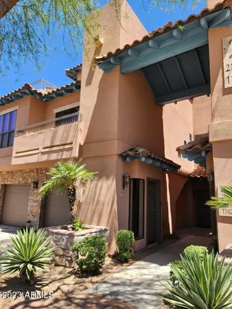 a front view of a house with plants