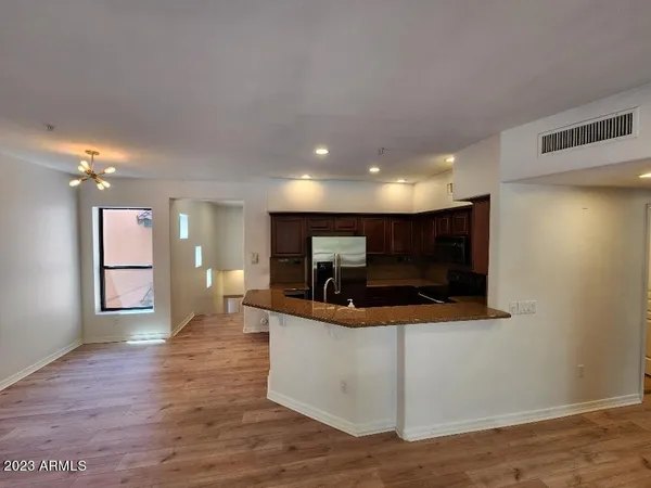 a view of kitchen with refrigerator and microwave