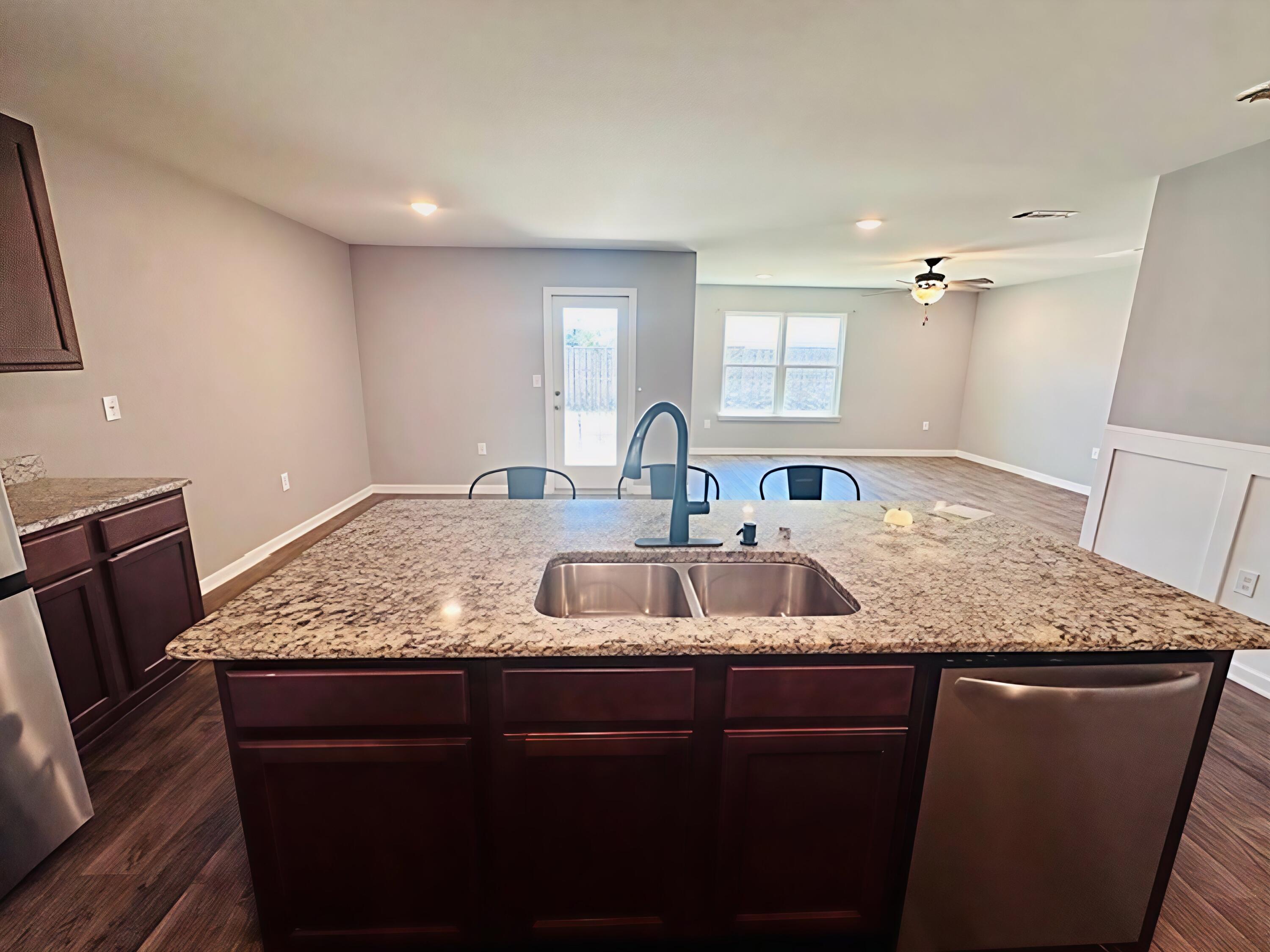 833 Moorhen Way Crestview, FL 32539 - Photo 4 of 18 a bathroom with a granite countertop sink a mirror and vanity