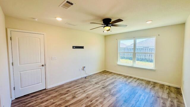 833 Moorhen Way Crestview, FL 32539 - Photo 6 of 18 a view of empty room with wooden floor and fan