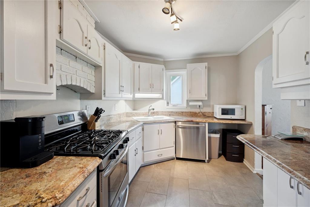 452 Airport Road Butler, PA 16002 - Photo 14 of 45 a kitchen with a sink stove top oven and cabinets