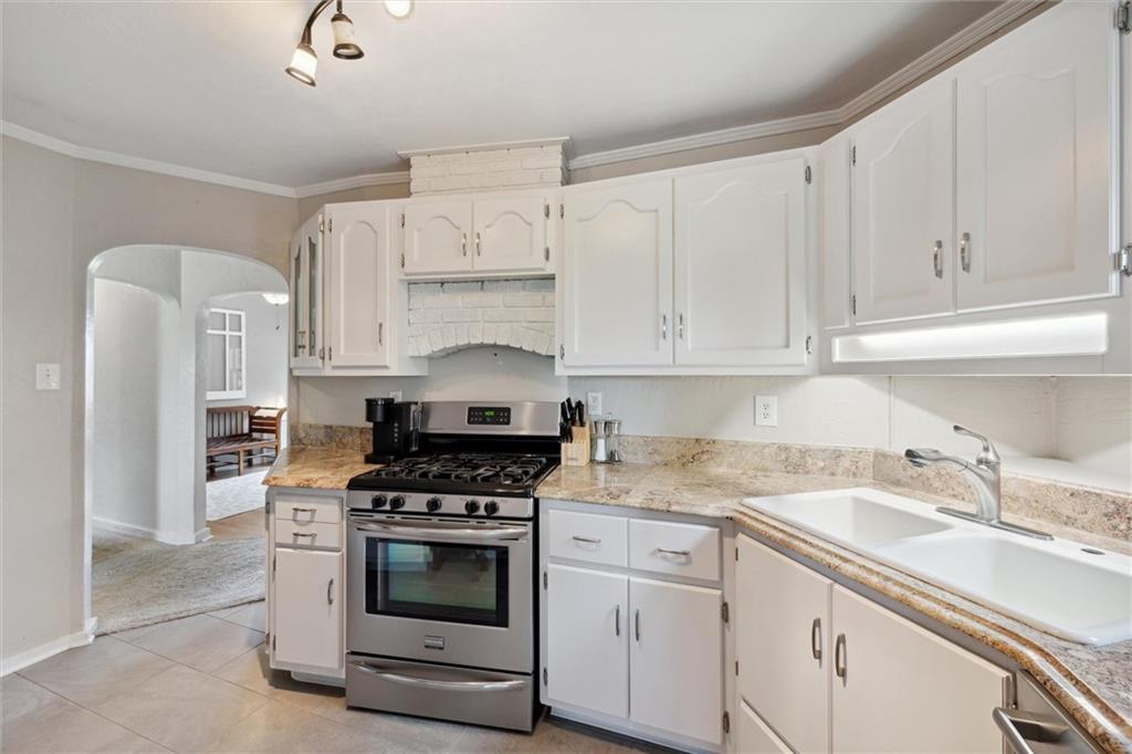 452 Airport Road Butler, PA 16002 - Photo 17 of 45 a kitchen with granite countertop white cabinets and white appliances