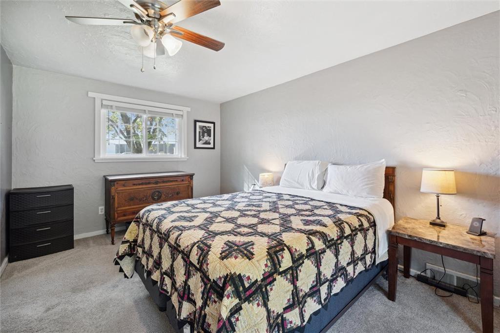 452 Airport Road Butler, PA 16002 - Photo 19 of 45 a bedroom with a bed and a chandelier