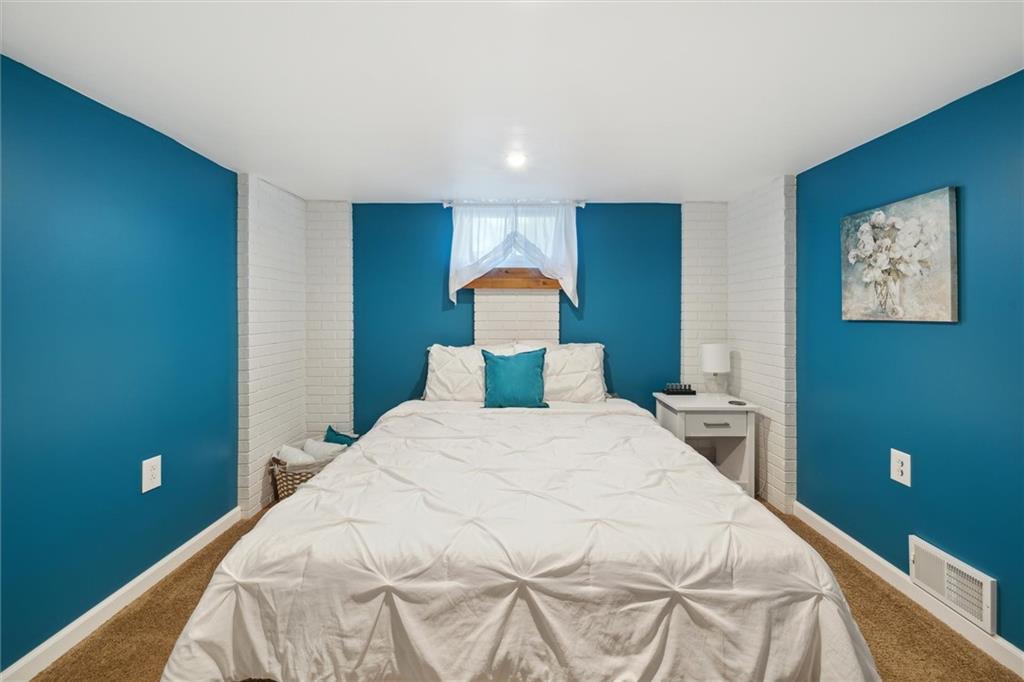 452 Airport Road Butler, PA 16002 - Photo 24 of 45 a bedroom with a bed and a lamp on dresser