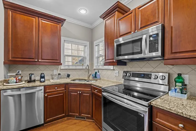 a bathroom with a double vanity sink a toilet and a mirror