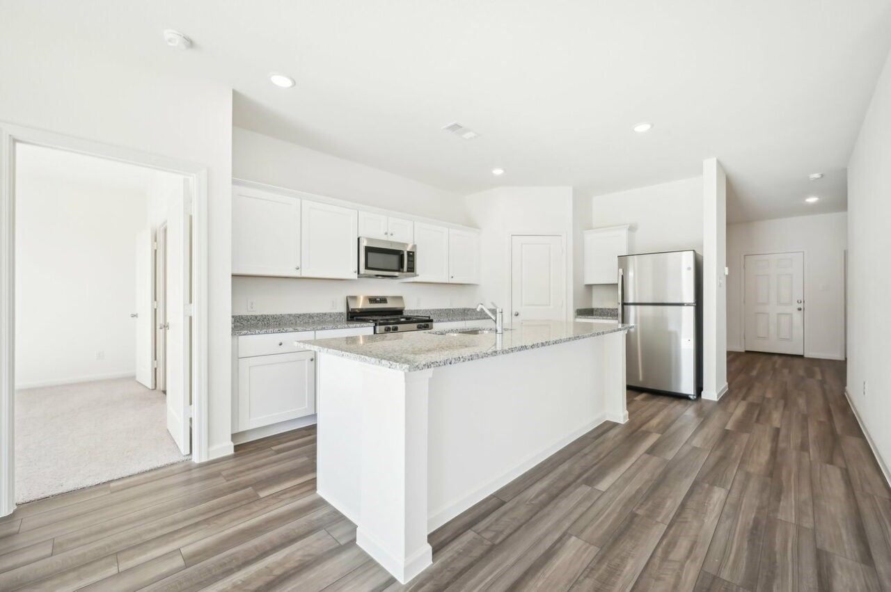 3118 Diamond Vw Lane Angleton, TX 77515 - Photo 2 of 7 a kitchen with white cabinets and stainless steel appliances