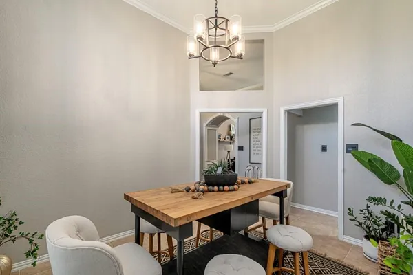 a view of a dining room with furniture and a chandelier