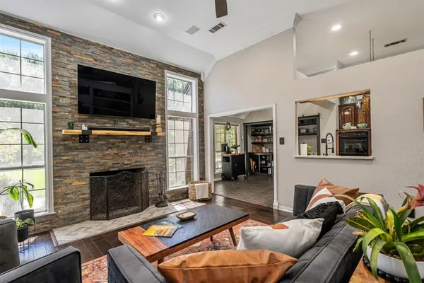 a living room with furniture fireplace and flat screen tv