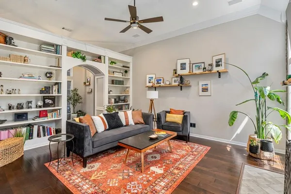 a living room with furniture and wooden floor