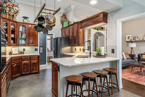 a kitchen with stainless steel appliances granite countertop a sink and a refrigerator