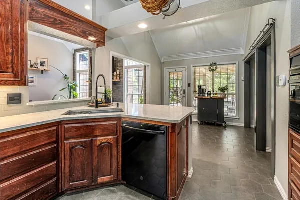 a kitchen with a sink appliances and cabinets