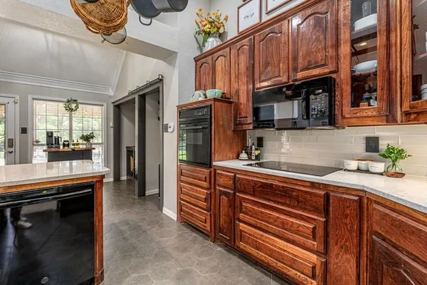 a kitchen with stainless steel appliances granite countertop a sink a stove and a refrigerator