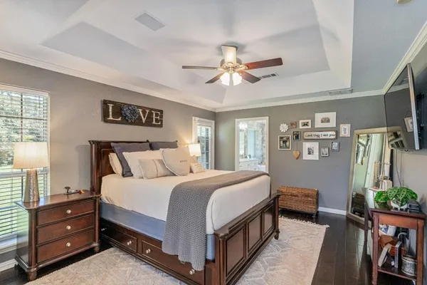 a bedroom with a bed dresser and a window