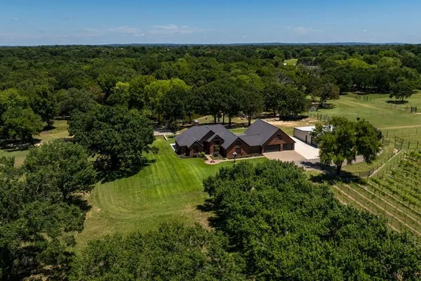 an aerial view of a house with a yard