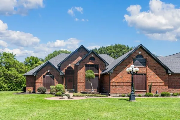 a front view of house with yard and green space