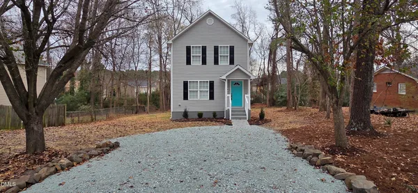 a front view of a house with a yard garage and outdoor seating