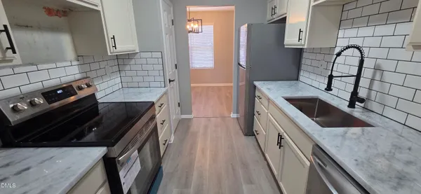a kitchen with granite countertop a stove and a sink