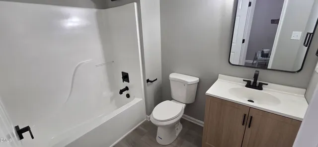 a white toilet sitting next to a bathroom sink