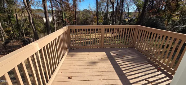 a view of balcony with wooden floor and fence