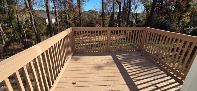 a view of balcony with wooden floor and fence