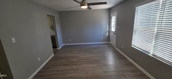 a view of a hallway with wooden floor and staircase