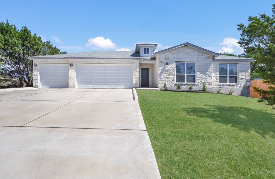 20303 Bear Road Lago Vista, TX 78645 - Photo 1 of 1 a front view of a house with a yard and garage
