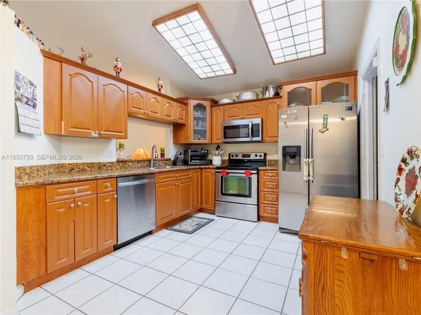 a kitchen with stainless steel appliances a refrigerator and a stove