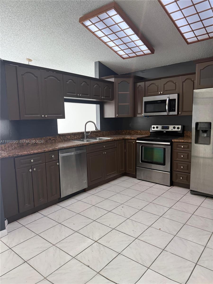206 Southwest 159th Way Sunrise, FL 33326 - Photo 61 of 61 a kitchen with stainless steel appliances granite countertop a sink counter space cabinets and a sink